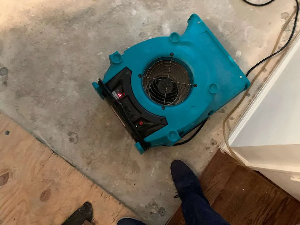 Air mover drying subfloor during Leak Detection & Repair in South Riding